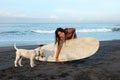 Beautiful Girl. Surfing Woman With Dog And Surfboard On Beach. Smiling Surfer Going To Surf.