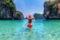 Beautiful girl surrounded by fish in Andaman Sea, Krabi, Thailand.