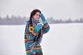 Beautiful girl in a sweater on a winter walk with a cup of coffee Royalty Free Stock Photo