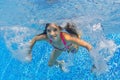 Beautiful girl swims underwater in pool