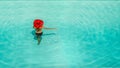 Beautiful girl in a swimsuit and a red hat in a blue water pool Royalty Free Stock Photo