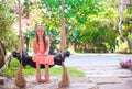 Beautiful girl swinging on a swing in cozy lovely Royalty Free Stock Photo