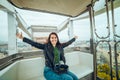 Beautiful girl taking picture at Ferris wheel on her phone Royalty Free Stock Photo