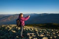 Beautiful girl taking picture with her smartphone in the mountains Royalty Free Stock Photo