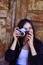 Beautiful girl taking picture with old camera Royalty Free Stock Photo