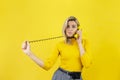 Beautiful girl talking at a vintage wired phone. Smothers itself with a telephone wire. Wireless concept Royalty Free Stock Photo