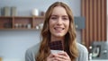 Beautiful girl tasting chocolate indoors. Smiling woman enjoying dark chocolate Royalty Free Stock Photo