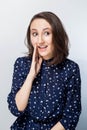 Beautiful girl telling a secret. Portrait young happy woman who is calling to someone. Expressive facial expressions Royalty Free Stock Photo