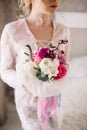 Beautiful girl in tender lacy dress with bouquet flowers peonies in hands standing against floral background in flower shop. Joyfu Royalty Free Stock Photo