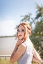 Beautiful girl in tender prom dress on river bank background. Female portrait Royalty Free Stock Photo