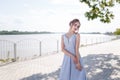 Beautiful girl in tender prom dress on river bank background. Female portrait on spring landscape. Royalty Free Stock Photo