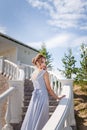 Beautiful girl in tender prom dress on stairs background. Female portrait Royalty Free Stock Photo