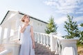 Beautiful girl in tender prom dress on stairs background. Female portrait Royalty Free Stock Photo