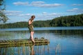 Beautiful girl touches the water