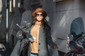 Beautiful girl tourist in glasses and a brown fashionable hat with a map in hand is looking for where to go Royalty Free Stock Photo