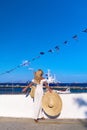 Beautiful girl tourist standing at Spetses marina seaport, Greece and looking at the sea Royalty Free Stock Photo