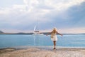 Beautiful girl tourist walking at Ermioni marina seaport, Greece Royalty Free Stock Photo