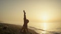 Beautiful girl training twine standing on head summer evening. Woman exercising. Royalty Free Stock Photo