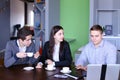 Three businessmen, woman and men discussing robot with cup of te Royalty Free Stock Photo