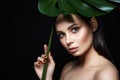 Beautiful girl under palm umbrella. Beautiful young woman with Make-up Royalty Free Stock Photo