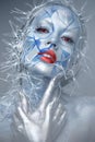 Beautiful girl in an unusual winter look with red lips. Creative make- up. Art look.