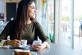 Beautiful girl using her mobile phone in cafe. Royalty Free Stock Photo