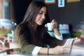 Beautiful girl using her mobile phone in cafe. Royalty Free Stock Photo