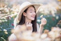 Beautiful girl in vintage dress and hat standing near colorful flowers Royalty Free Stock Photo