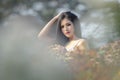 Beautiful girl in vintage dress and hat standing near colorful flowers Royalty Free Stock Photo