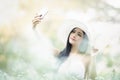 Beautiful girl in vintage dress and hat standing near colorful flowers Royalty Free Stock Photo