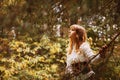 Beautiful girl in a vintage dress walking in a Summertime park. Trees. Forest