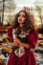 Beautiful girl in vintage red dress with a rose