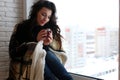 beautiful girl waiting for love sitting on the windowsill wrappe Royalty Free Stock Photo