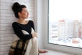 beautiful girl waiting for love sitting on the windowsill wrappe Royalty Free Stock Photo