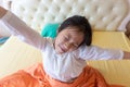 Beautiful girl waking up in her bed,Asian girl smiling and stretching,healthy ,lifestyle concept Royalty Free Stock Photo