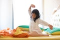 Beautiful girl waking up in her bed,Asian girl smiling and stretching,healthy lifestyle,wellness concept