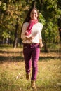 Beautiful girl walking on autumn park Royalty Free Stock Photo