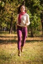 Beautiful girl walking on autumn park Royalty Free Stock Photo