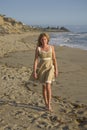 Beautiful Girl walking on the Beach in dress Royalty Free Stock Photo