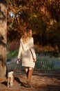 Beautiful girl walking her dog Cavalier King Charles Spaniel in the park Royalty Free Stock Photo