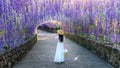 Beautiful girl walking at purple flower tunnel in Chiang Rai, Thailand Royalty Free Stock Photo