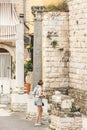 Beautiful girl walking among the remains and columns of a Roman Temple in Bari old town, Puglia