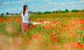 Beautiful girl walks in a poppy field Royalty Free Stock Photo