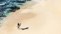 Beautiful girl walks with a surfboard on a wild beach Royalty Free Stock Photo