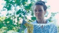 Beautiful girl washes window running squeegee on glass