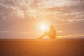 Beautiful girl watching the beautiful sunset on the water Royalty Free Stock Photo