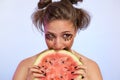Beautiful girl with watermelon, isolated on studio background. Food, fashion concept, space for text. Funny cute female model