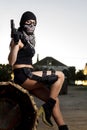 Beautiful girl with weapon and mask Royalty Free Stock Photo