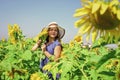 beautiful girl wear straw summer hat in field. pretty kid with flower. beauty of summer nature. little girl in sunflower Royalty Free Stock Photo