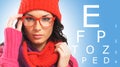 Beautiful girl wearing glasses checking her eyes Royalty Free Stock Photo